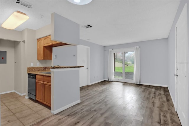 kitchen featuring electric panel, light hardwood / wood-style floors, and dishwasher