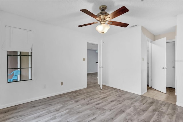 unfurnished bedroom with ceiling fan and light hardwood / wood-style floors