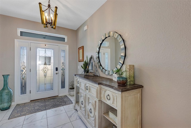 foyer entrance featuring an inviting chandelier