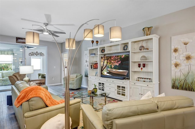 living room featuring hardwood / wood-style floors and ceiling fan