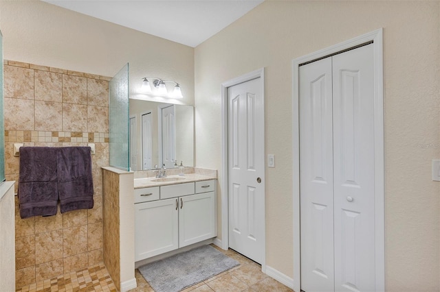 bathroom with vanity, tile patterned floors, and a tile shower