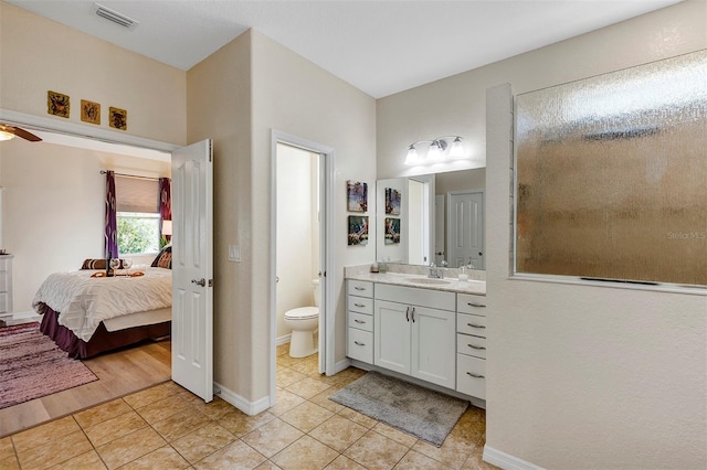 bathroom featuring vanity, tile patterned floors, ceiling fan, and toilet