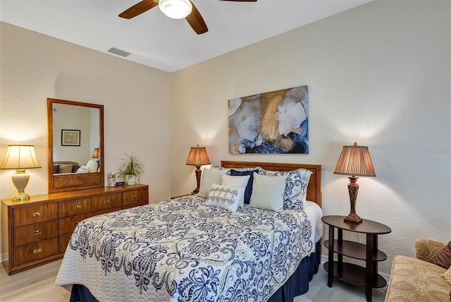 bedroom with ceiling fan and light hardwood / wood-style flooring