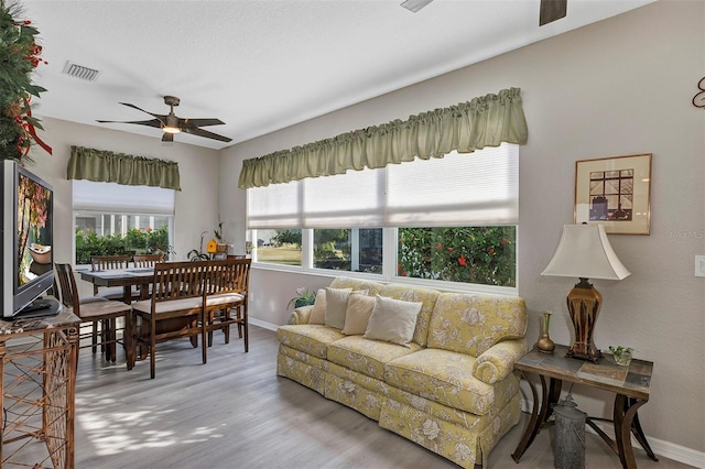 living room featuring ceiling fan and light wood-type flooring