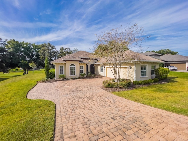 view of front facade featuring a garage and a front lawn