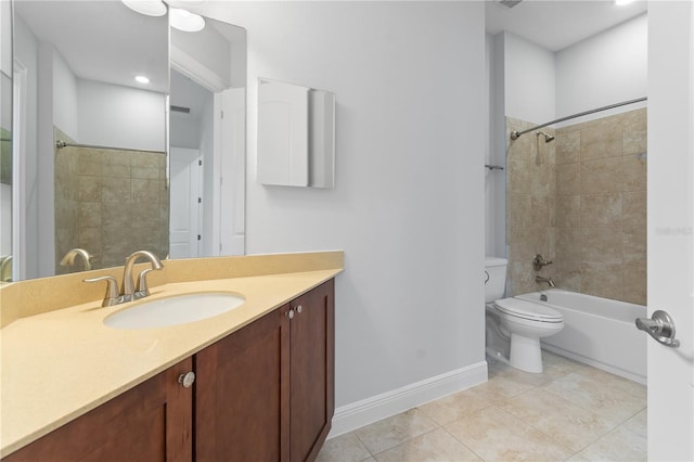 full bathroom featuring tiled shower / bath, vanity, toilet, and tile patterned flooring