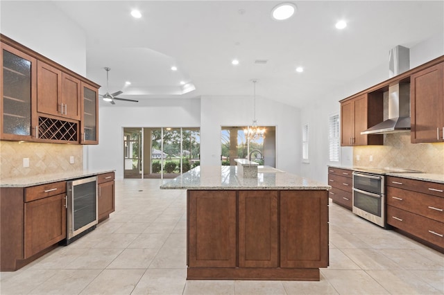 kitchen with wine cooler, wall chimney exhaust hood, sink, pendant lighting, and stainless steel appliances