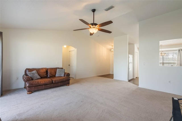 carpeted living room with high vaulted ceiling and ceiling fan