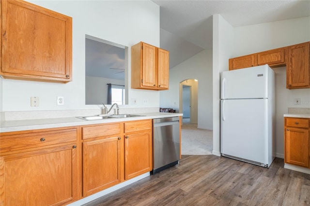 kitchen featuring lofted ceiling, sink, dark wood-type flooring, stainless steel dishwasher, and white fridge