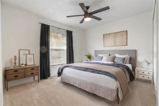 bedroom with light carpet and ceiling fan