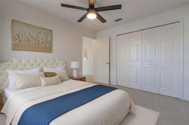 carpeted bedroom with ceiling fan and a closet