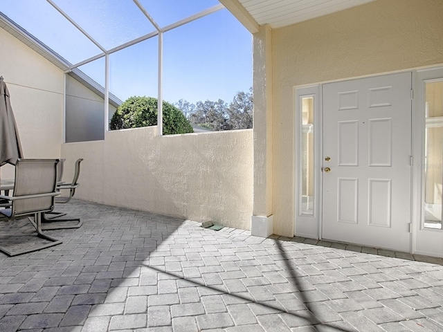 view of patio / terrace featuring glass enclosure