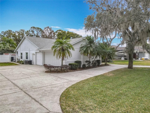 view of property exterior featuring cooling unit, a garage, and a yard