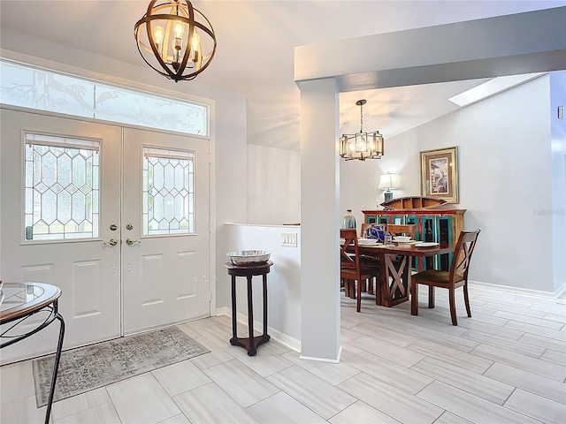 foyer entrance featuring an inviting chandelier and french doors