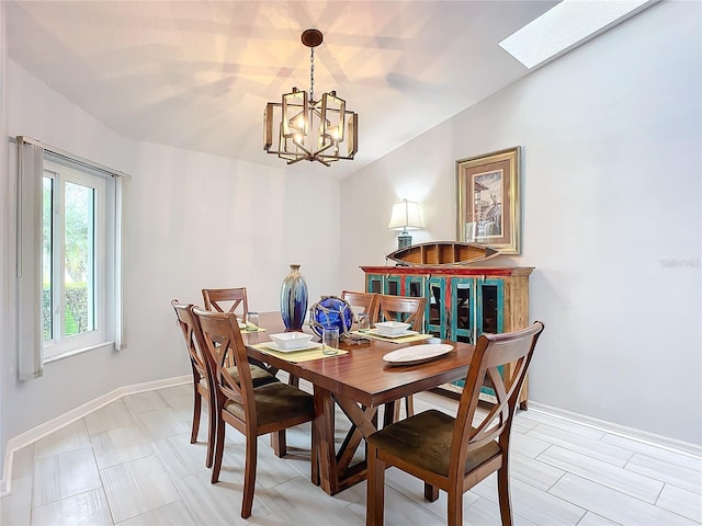 dining space featuring a chandelier and vaulted ceiling