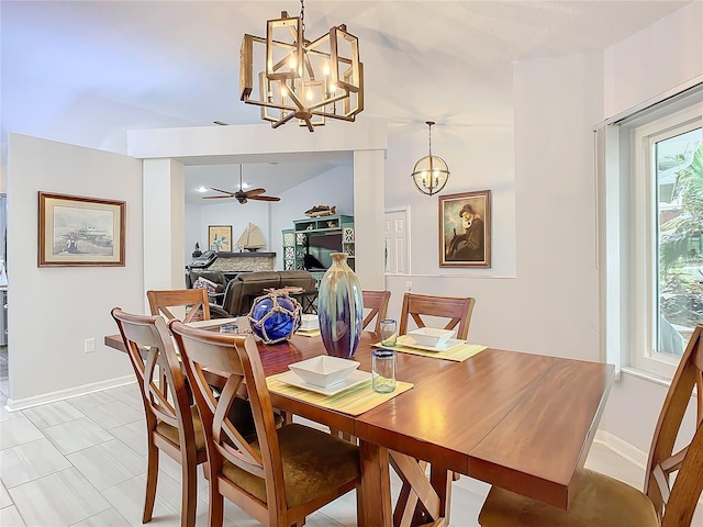 dining area with ceiling fan with notable chandelier