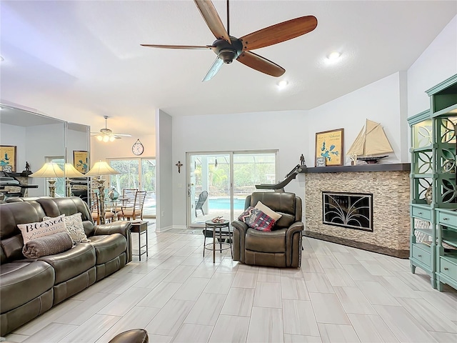 living room with a stone fireplace and ceiling fan