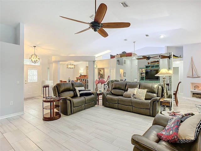 living room featuring ceiling fan with notable chandelier and vaulted ceiling