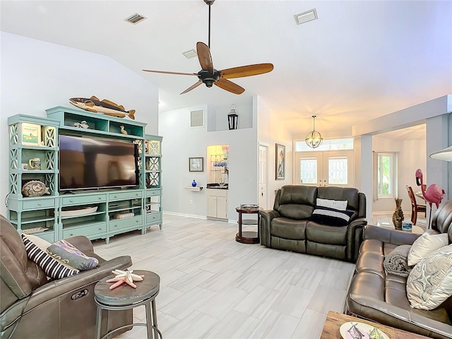 living room featuring lofted ceiling, ceiling fan, and french doors