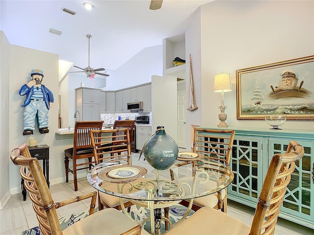 dining room featuring high vaulted ceiling and ceiling fan