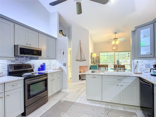 kitchen featuring lofted ceiling, sink, ceiling fan, gray cabinetry, and stainless steel appliances