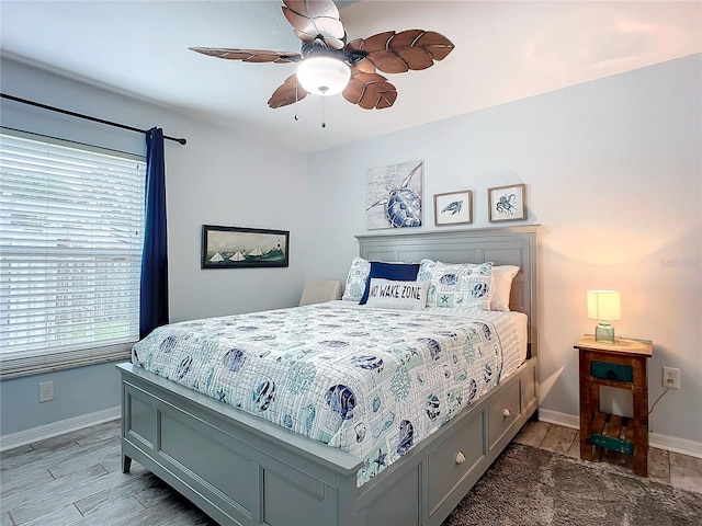 bedroom with ceiling fan and light hardwood / wood-style floors