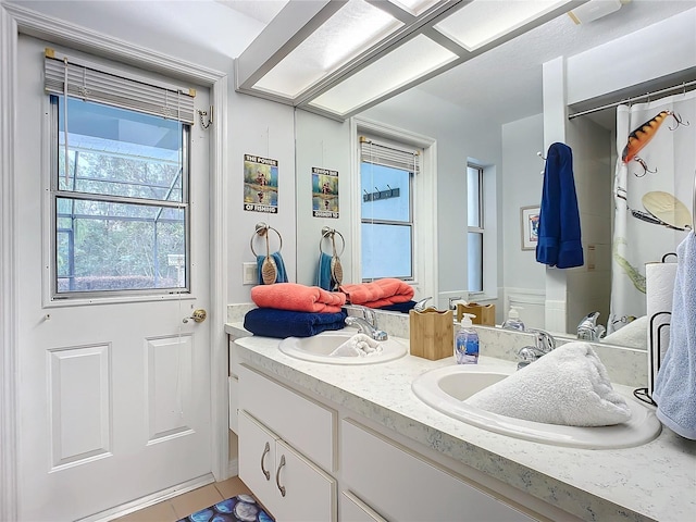 bathroom with tile patterned flooring and vanity