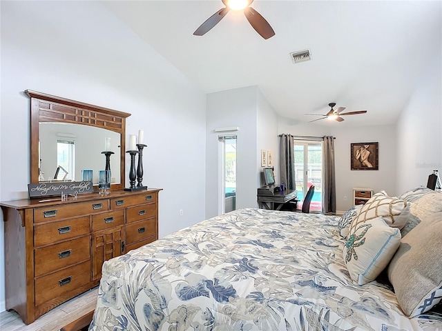 bedroom featuring light hardwood / wood-style flooring, access to outside, ceiling fan, and vaulted ceiling