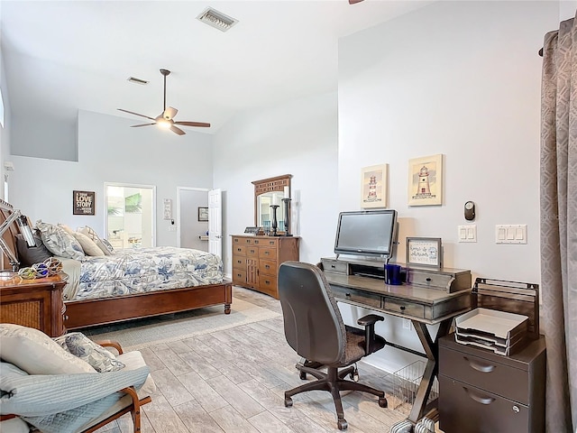 bedroom featuring light hardwood / wood-style flooring, high vaulted ceiling, and ceiling fan