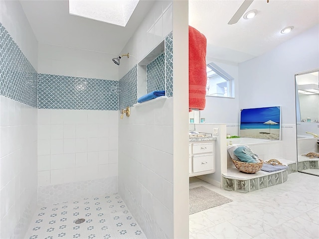 bathroom featuring vanity and tiled shower