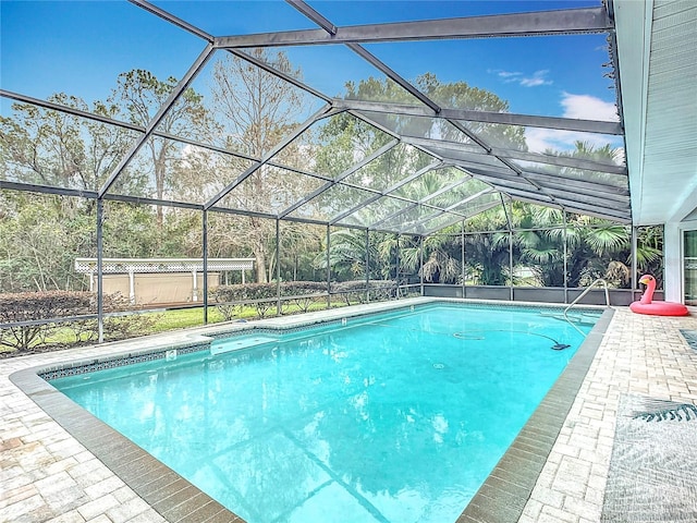 view of swimming pool with a lanai and a patio area