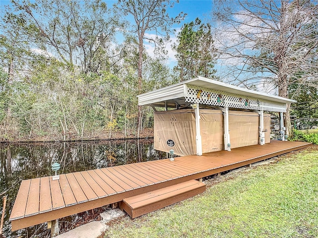 wooden deck featuring a water view and a yard