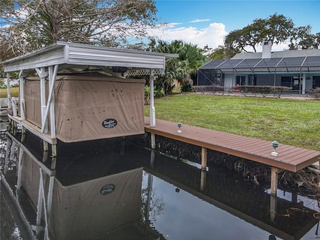 dock area featuring glass enclosure and a lawn