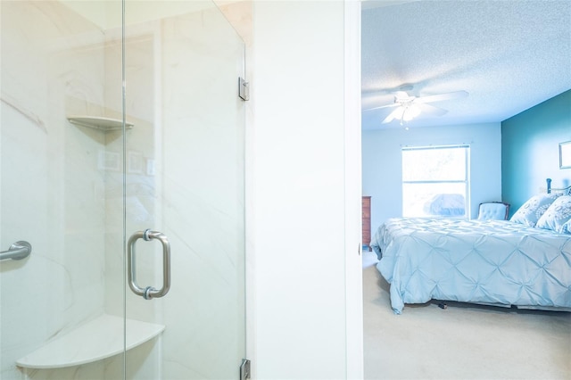 bedroom with ceiling fan and a textured ceiling