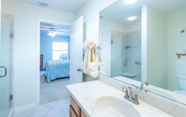 ensuite bathroom with a textured ceiling, connected bathroom, visible vents, vanity, and a stall shower