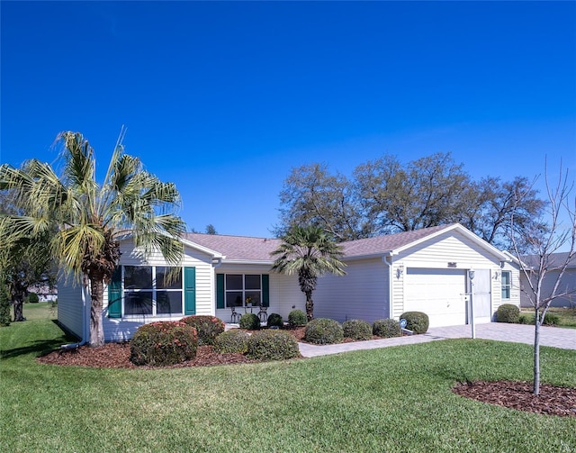 ranch-style home featuring a garage, a front yard, and concrete driveway