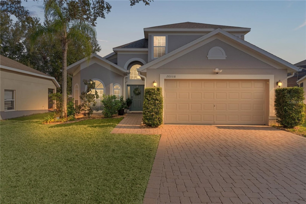 view of front of home with a garage and a front yard