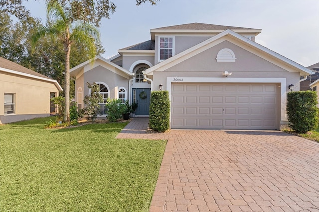 view of front of house with a garage and a front lawn