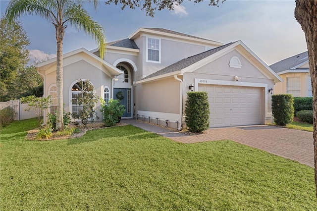 view of front of house featuring a garage and a front lawn