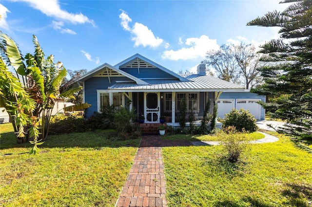 view of front facade featuring a garage, a front yard, and covered porch