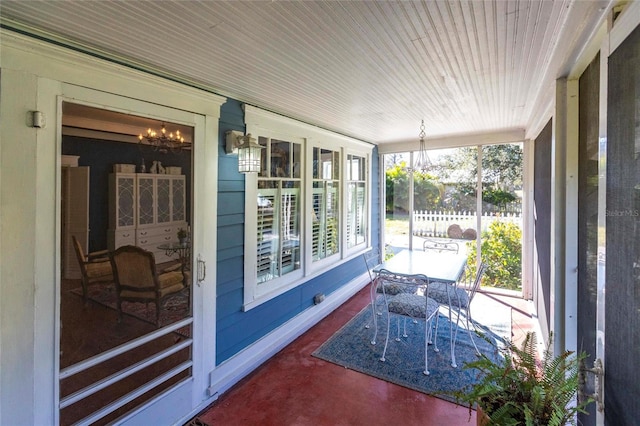 sunroom featuring a notable chandelier