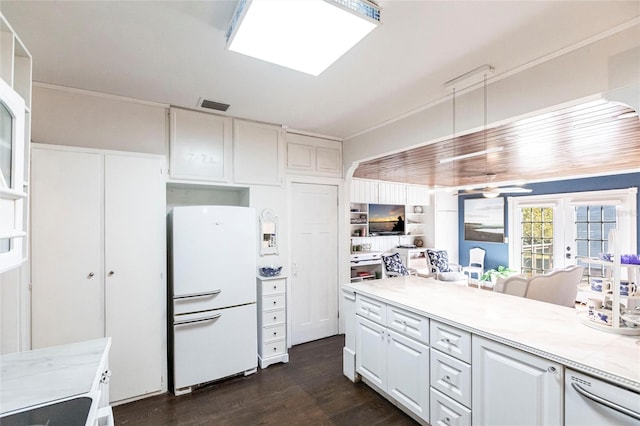 kitchen featuring white fridge, dark wood-type flooring, white cabinets, and french doors