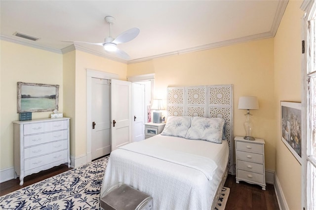 bedroom with crown molding, dark wood-type flooring, and ceiling fan