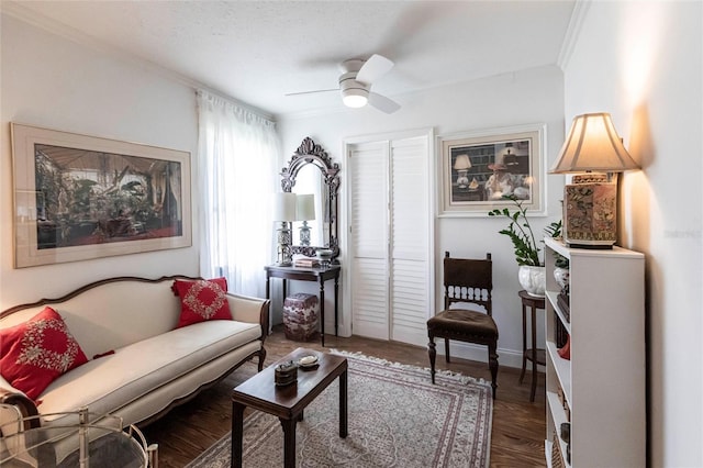 sitting room with crown molding, dark hardwood / wood-style floors, and ceiling fan