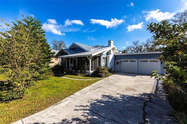 view of front facade with a garage, a sunroom, and a front lawn