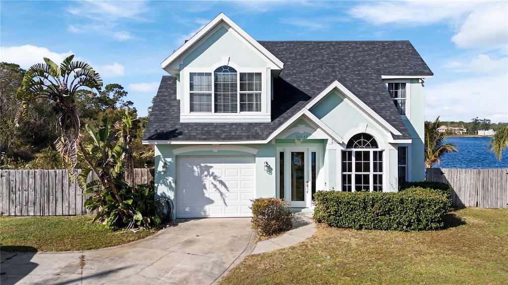 view of front of property featuring a garage and a front yard