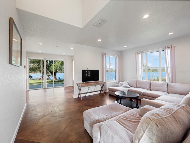 living room featuring tile patterned flooring and a textured ceiling