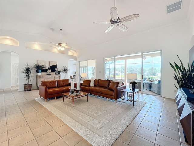 living room featuring light tile patterned floors, a healthy amount of sunlight, and ceiling fan