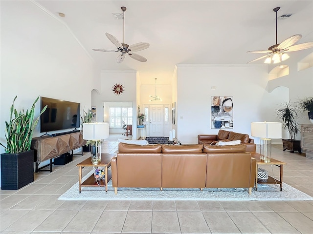 living room featuring high vaulted ceiling, ceiling fan, and light tile patterned flooring