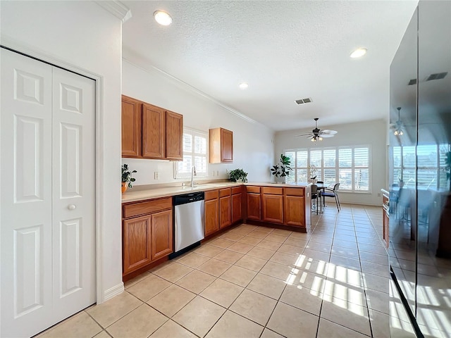 kitchen with stainless steel dishwasher, kitchen peninsula, a textured ceiling, and light tile patterned flooring